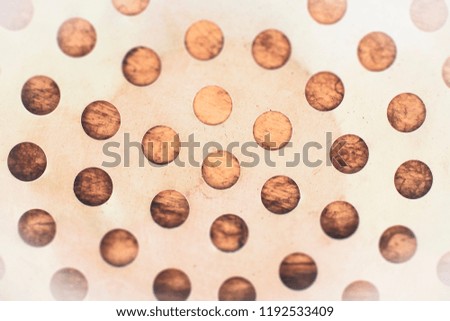 The metal drilled holes holes to make a background.