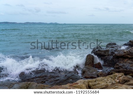 The sea wave clashing on the rocky shore.