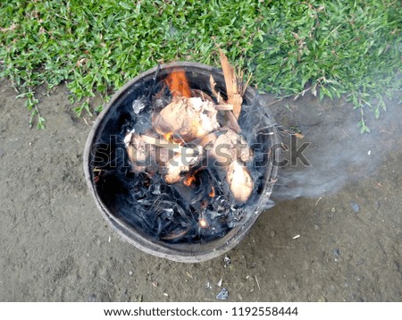 Empty flaming charcoal grill with open fire, ready for product placement. Concept of summer grilling, barbecue, bbq and party.