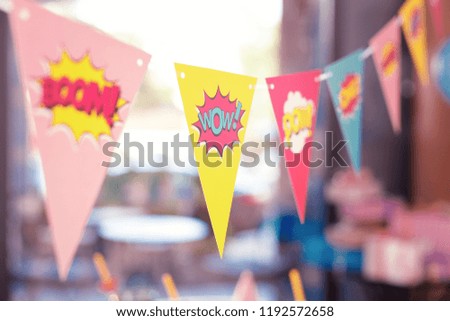 Cute flags. Adorable bright laconic party flags with funny signs placed in the room