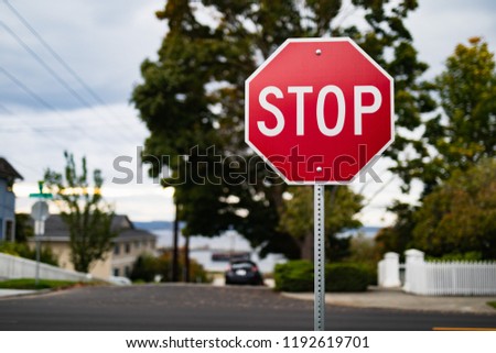A close up photo of a red stop sign in a residential neighborhood.
