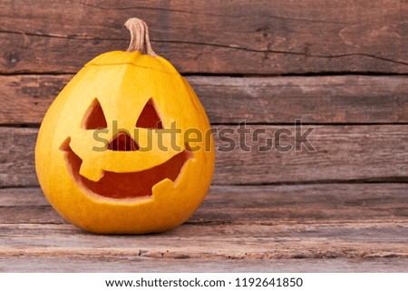 Halloween pumpkin with copy space. Funny halloween pumpkin on rustic background with text space. Happy Halloween concept.