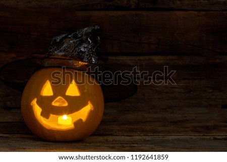 The candle inside of the Jack-O-Lantern. Funny Halloween pumpkin with burning candle and wizard hat. Halloween pumpkin ideas.