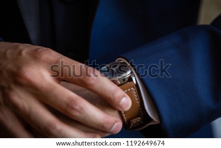 Groom looking at his watch Royalty-Free Stock Photo #1192649674
