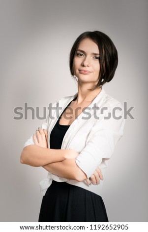 beautiful successful girl with arms crossed on chest, short haircut, isolated over background