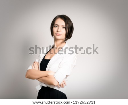 beautiful successful girl with arms crossed on chest, short haircut, isolated over background