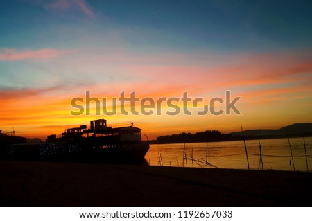 Silhouette of the stunning port along the banks of the Brahmaputra river with the boats in the foreground taken in the Indian city of Guwahati,Assam