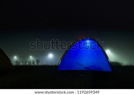Blue tent in the night with stars and foggy.