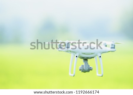 drone copter flying with digital camera, Flying camera take a photo and video with professional camera takes pictures view of the misty mountains,Electric drone flies in the sky.