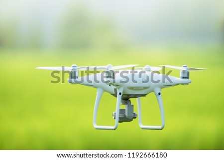 drone copter flying with digital camera, Flying camera take a photo and video with professional camera takes pictures view of the misty mountains,Electric drone flies in the sky.