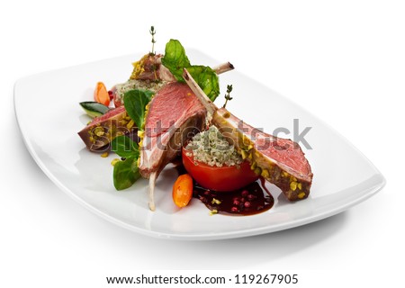Roasted Lamb Chops with Pistachio. Garnished with Vegetables and Basil Royalty-Free Stock Photo #119267905