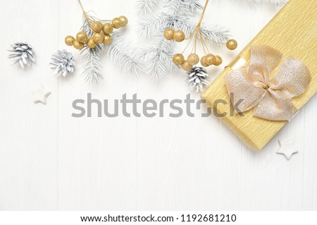 Mockup Christmas white tree, beige bow, gift box and cone. Flat lay on a white wooden background, with place for your text. Top view