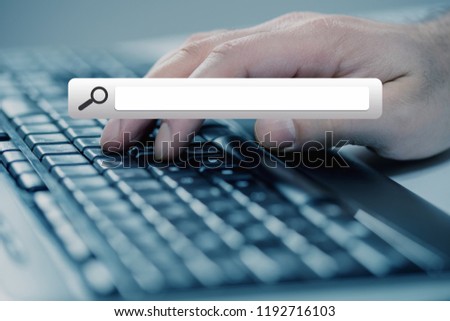 Man hand typing on keyboard with seach button Royalty-Free Stock Photo #1192716103