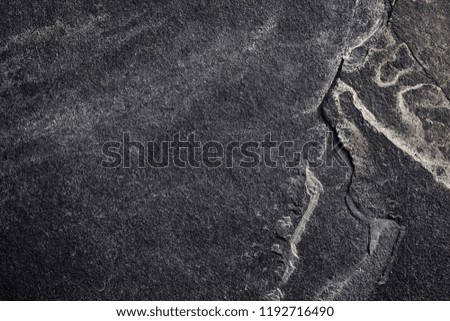 Top view of a dark slate background or texture.