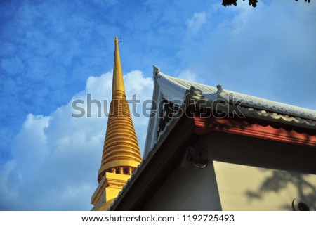 Golden Pagoda and Temple in bangkok thailand on blue sky background.
