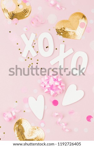 Confetti, bows and paper decorations. Valentines day or birthday party concept theme. Flat lay, top view
