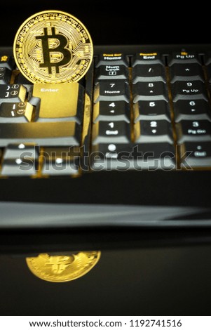 Bitcoin on a black computer keyboard. E-commerce. Virtual currency. Exchange speculation. Loss on the stock exchange. Share price