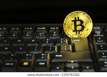 Bitcoin on a black computer keyboard. E-commerce. Virtual currency. Exchange speculation. Loss on the stock exchange. Share price