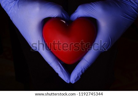 Hand and heart shape isolated on black