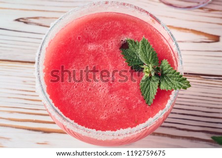Drink smoothies from red watermelon in glass dishes decorated white sugar and mint leaves Pieces of fruit on cutting board white table concept of healthy eating diet detox.