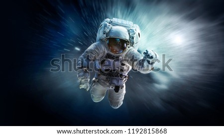 Astronaut in deep space floating in weightlessness. Galaxy on the background. Space art wallpaper. Elements of this image furnished by NASA