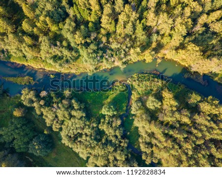 Aerial view of small river inflowing to big. Autumn forest.