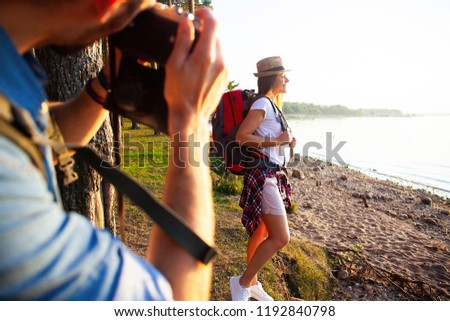 Happy young couples traveler with backpack take photo at forest, Travel and hiking concept