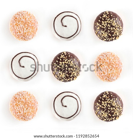 Top view of nine doughnuts different kinds isolated on white background