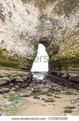 Natural arch sea cave in chalk cliffs