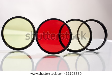 Row of four photo filters with reflection