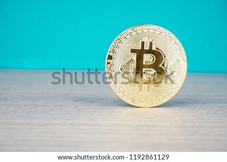 Bitcoin digital decentralised peer to peer on a wooden surface and green background. selective focus