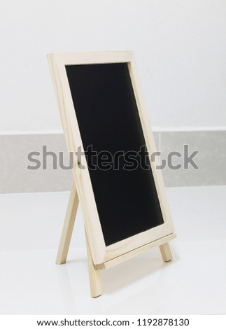 blank slate blackboard on white floor background, copy space.