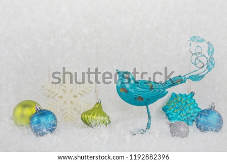 Christmas ornaments and blue bird on a vintage snowy background