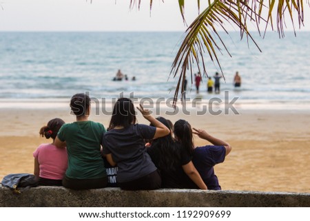 Kota Kinabalu, Sabah, Malaysia-August 31, 2018: A group of unidentified local visitor taking selfie picture in Tanjung Aru Beach Kota Kinabalu, Sabah, Malaysia.