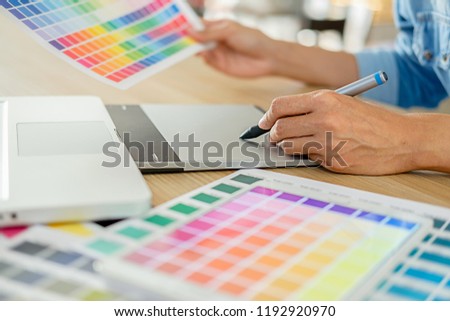 Graphic design and color swatches and pens on a desk. Architectural drawing with work tools and accessories.