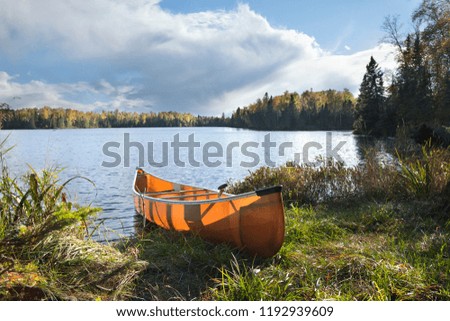 Canoe on the shore of a beautiful northern Minnesota lake during autumn
