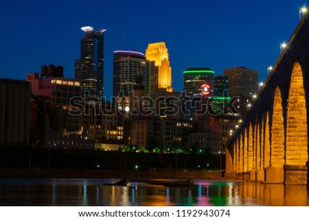 Downtown Minneapolis, Minnesota in the night with famous Stone Arch Bridge