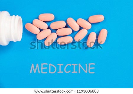 scattered pills on a blue background
