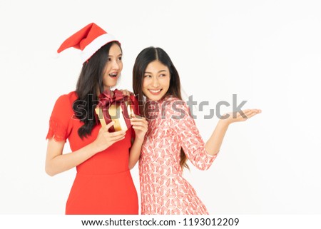 Photo of asian curious woman in red dress rejoicing her birthday or new year gift box. Young woman holding gift  box with red bow being excited and surprised  holiday present isolated white background