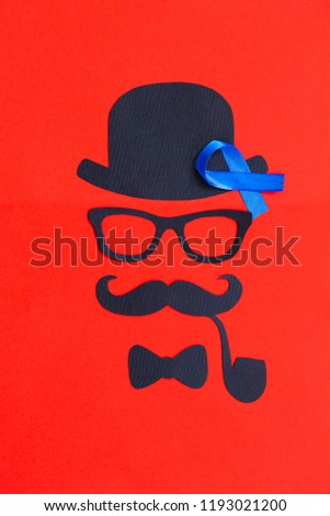 Male silhouette with mustache, glasses and hat patterns on the red background. Prostate Cancer and men's health awareness. Funny party faces. Copy space