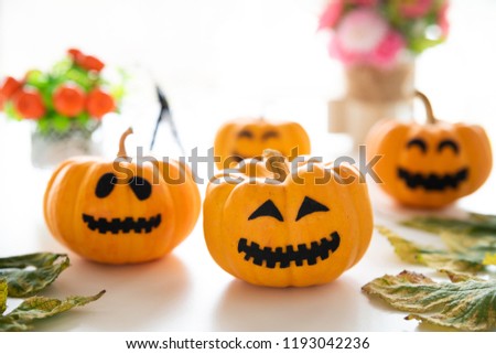 White and yellow ghost pumpkins with witch hat and Happy halloween text on borad. halloween concept.