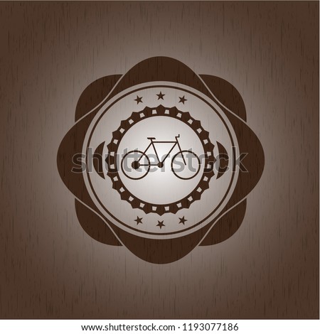 bike icon inside wooden emblem