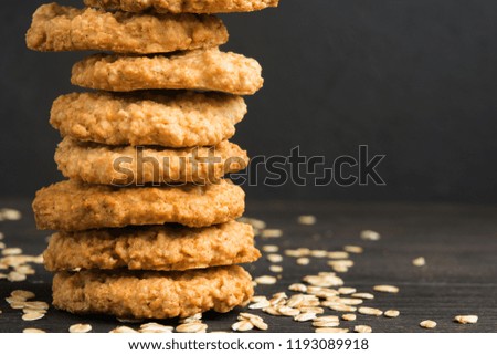Homemade oatmeal cookies on wooden table with copy space, dark photo