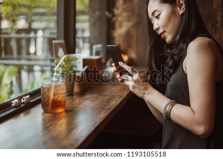 woman capturing photos of ice tea.