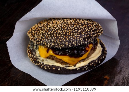 Black burger with cutlet and cheese