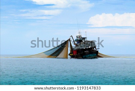 Large fishing trawlers are fishing in the sea. Royalty-Free Stock Photo #1193147833