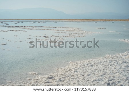 Milky blue salty waters of Dead Sea with mountains on a background, Israel. Horizontal Landscape photo