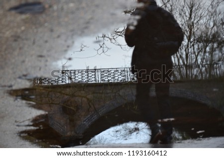 Reflections in the water. Captures this upside down scene through the reflection of the water paddle when a man was walking past. Quite abstract