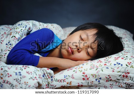 Handsome boy sleeping peacefully Royalty-Free Stock Photo #119317090