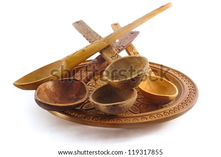Wooden plate and spoons on a white background